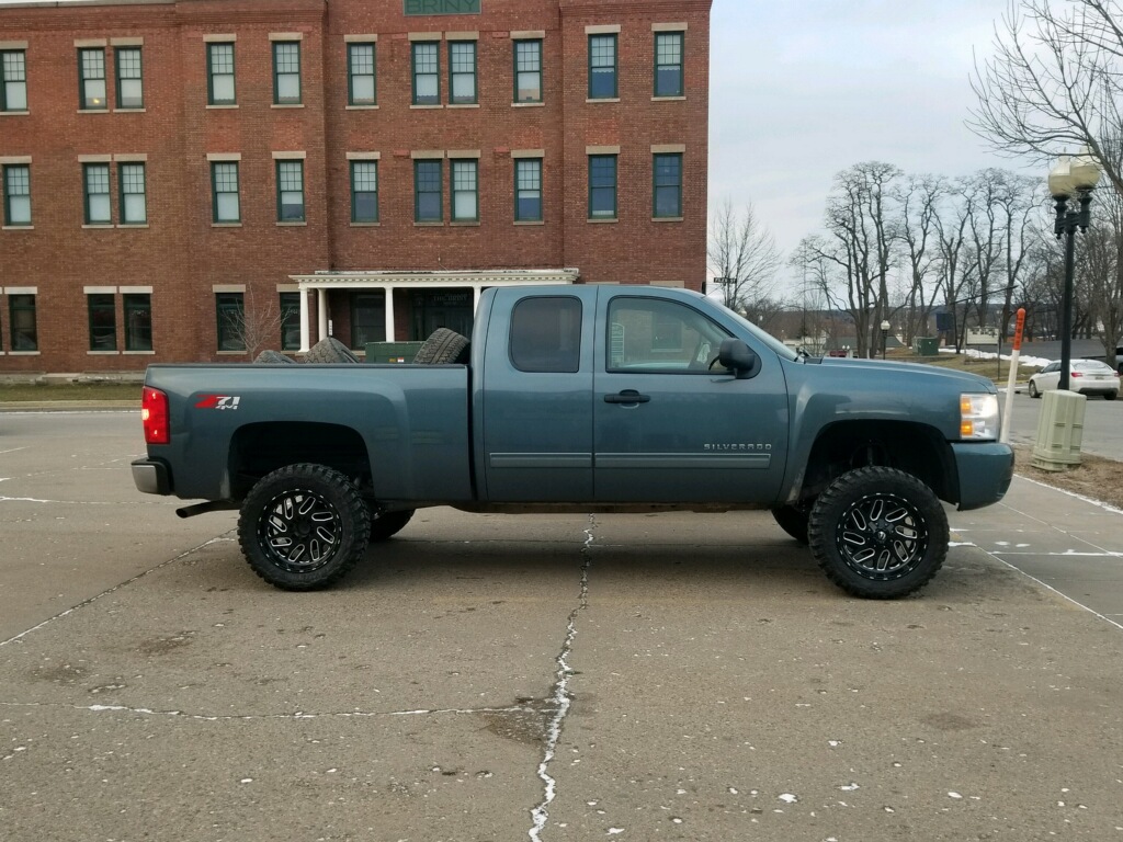 Truck with Rough Country 6 inch lift kit installed and mud tires